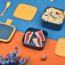 Blue lunch box with handle and spoon for meals