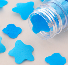 Flower-shaped paper soap strips in a compact test tube bottle.